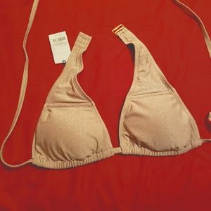 Light blush pink, metallic bikini top. New with tags. Never worn Size small.